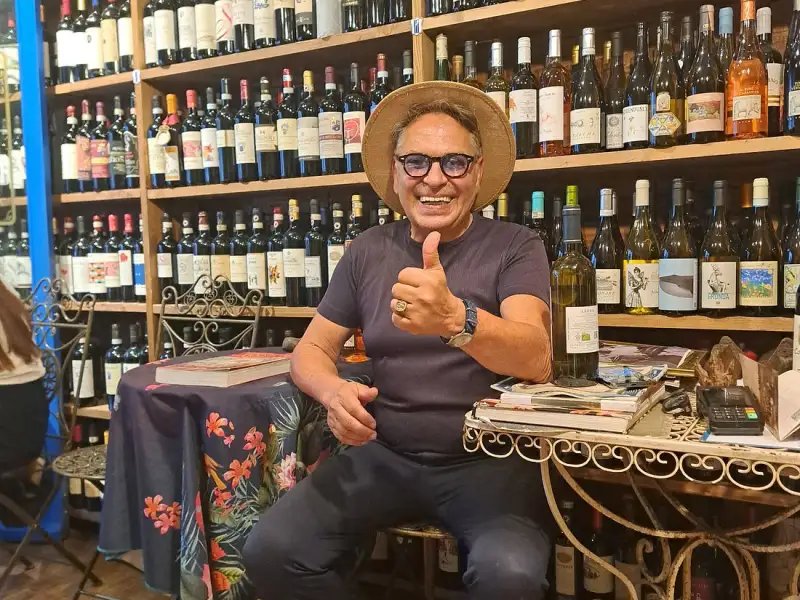 Leonardo in the Antiche Dogane wine shop in Florence, surrounded by shelves of Italian wine